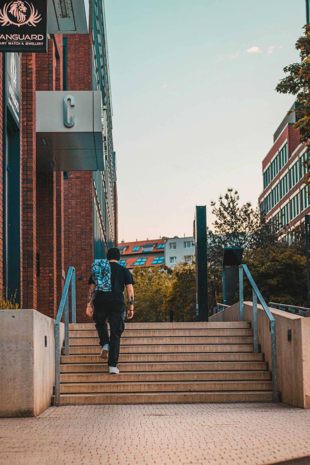 a man with a backpack walking up some stairs