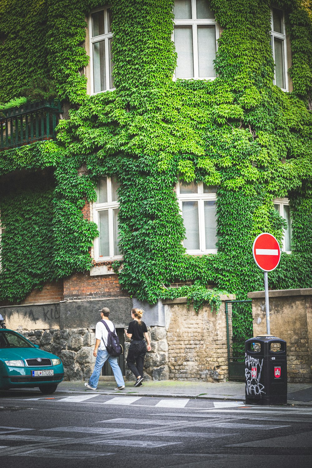 a group of people crossing a street in front of a building