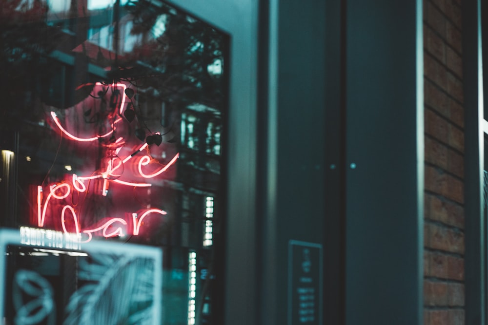 a neon sign in a window of a restaurant