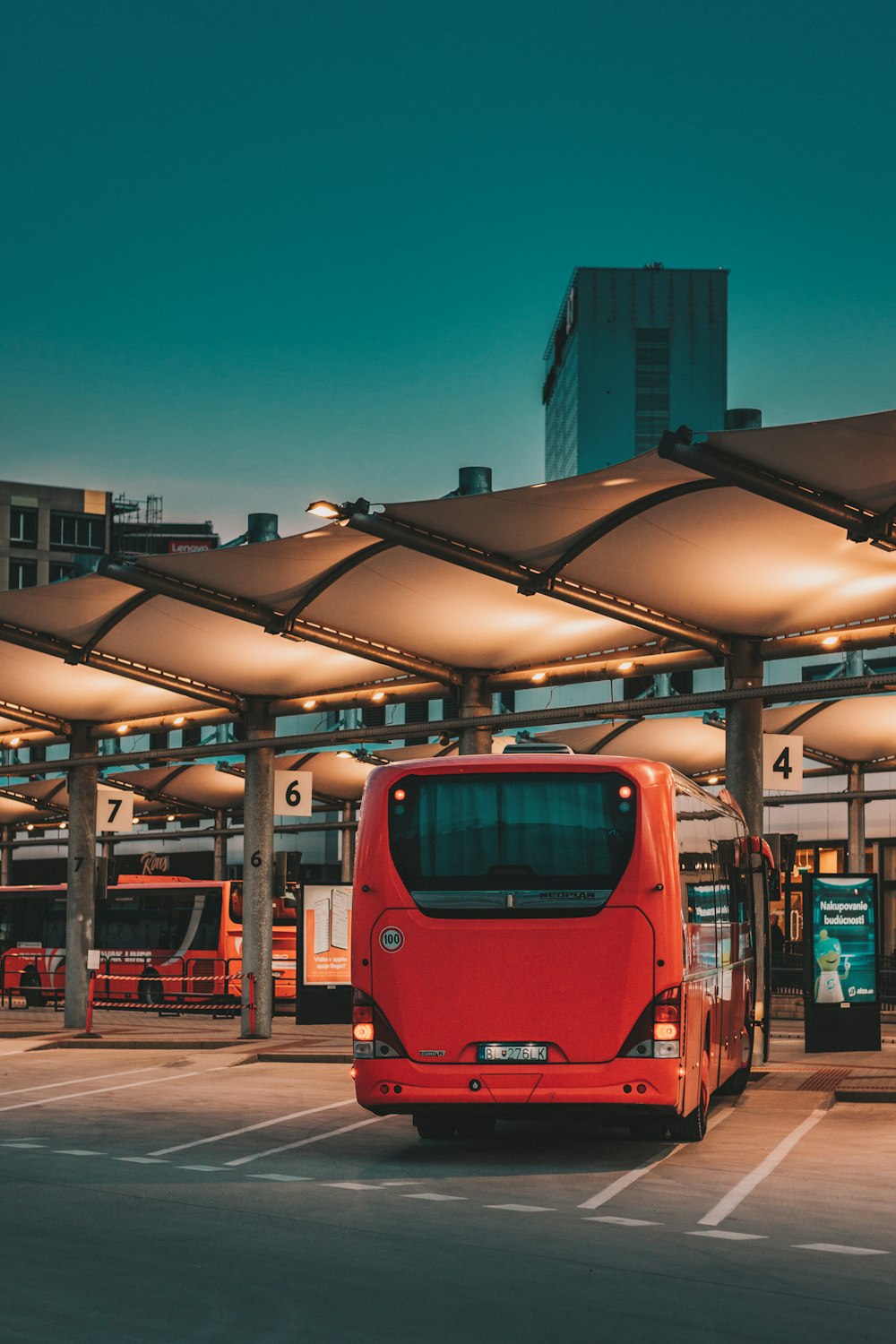 a red bus parked at a bus stop