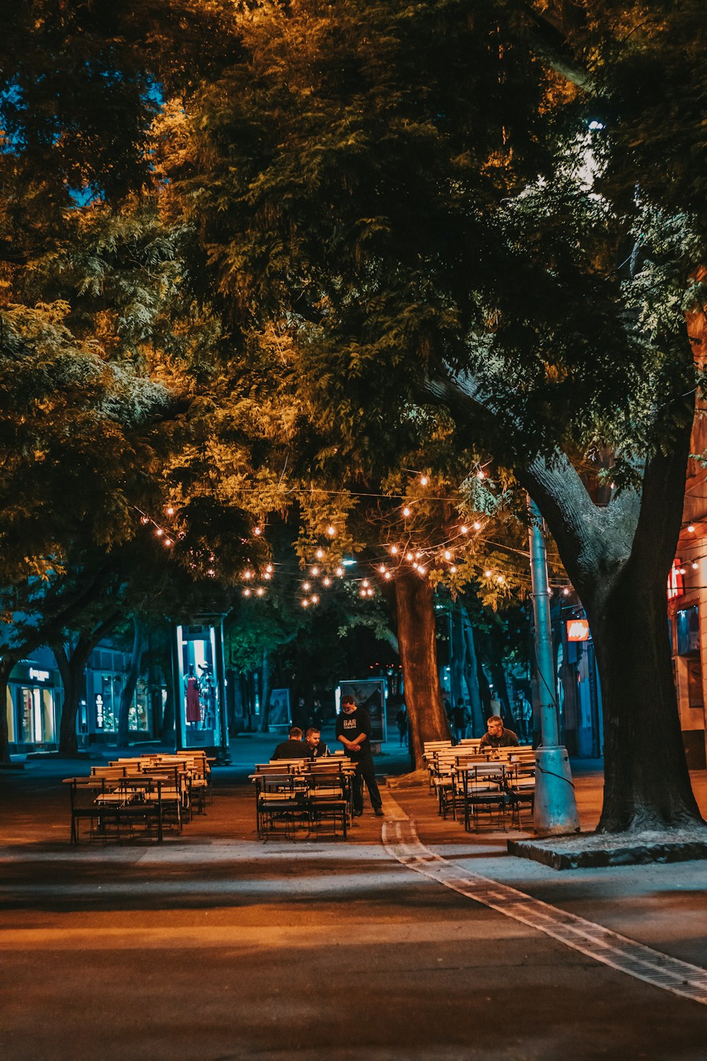 a person walking down a street at night