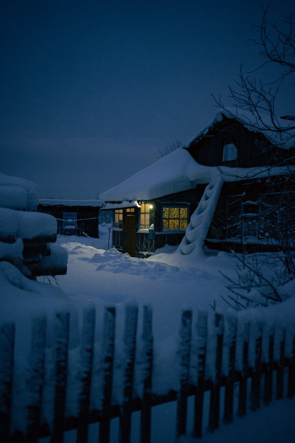 a house is covered in snow at night