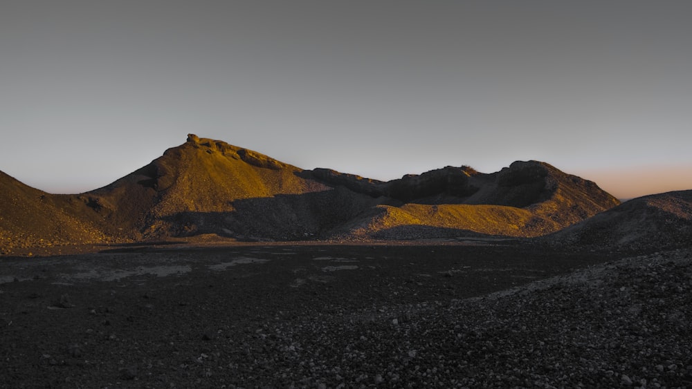 the sun is setting on the mountains in the desert