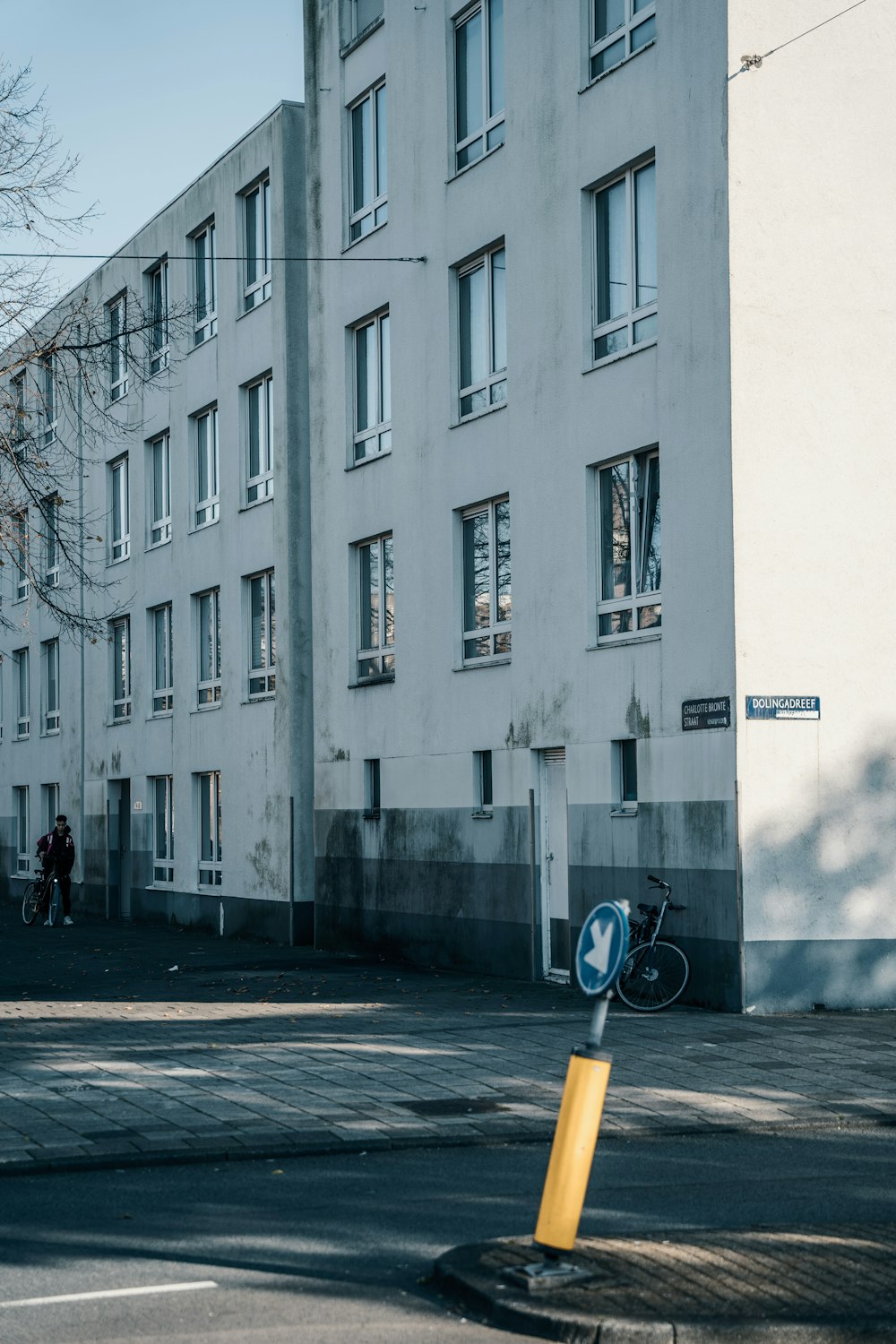 a tall white building sitting on the side of a road