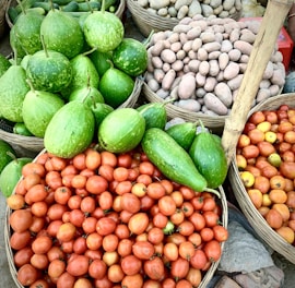 a pile of baskets filled with lots of fruits and vegetables