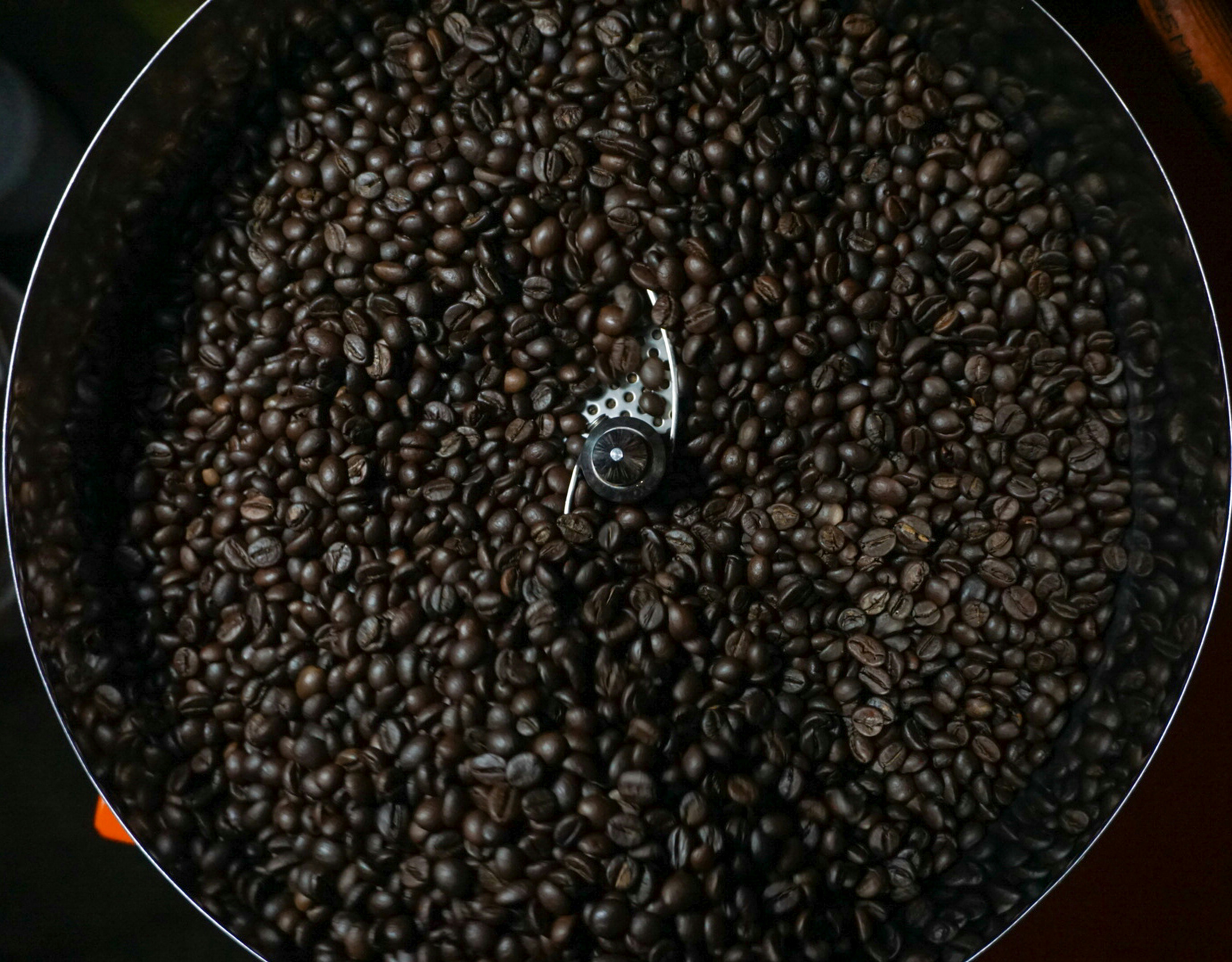Overhead view of dark beans in a round drum