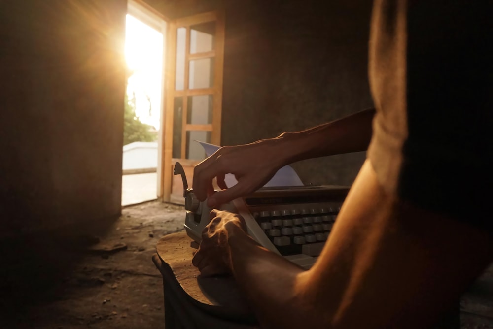 a person using a knife to cut a piece of wood