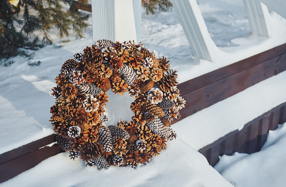 a wreath sitting on top of snow covered ground