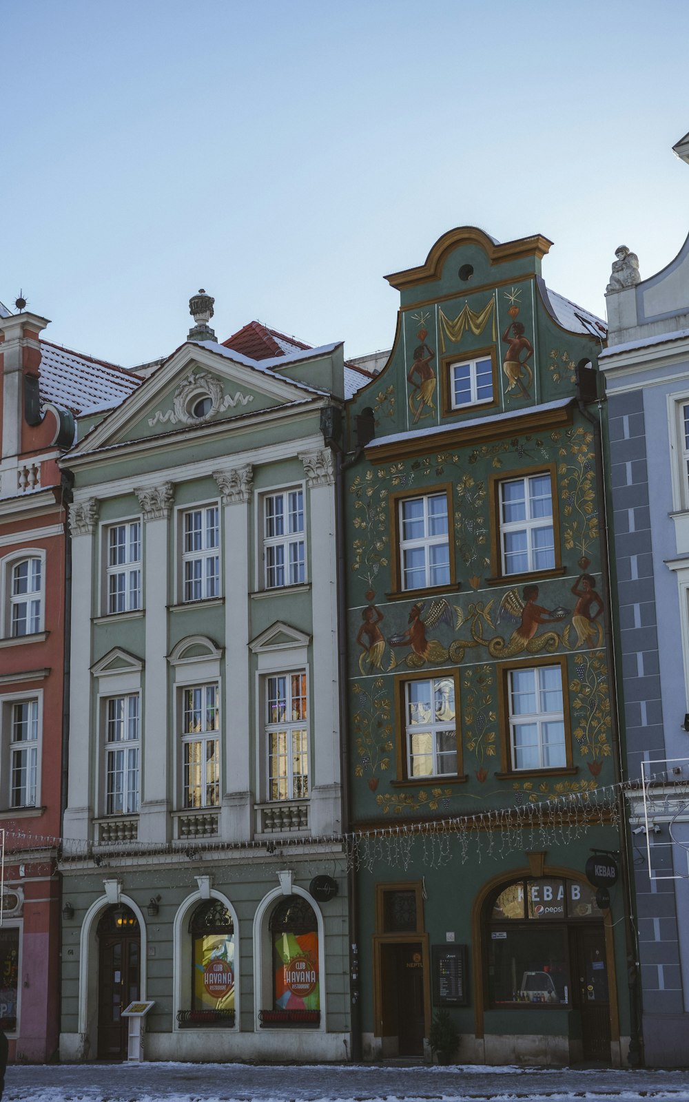 a row of buildings with a clock tower on top