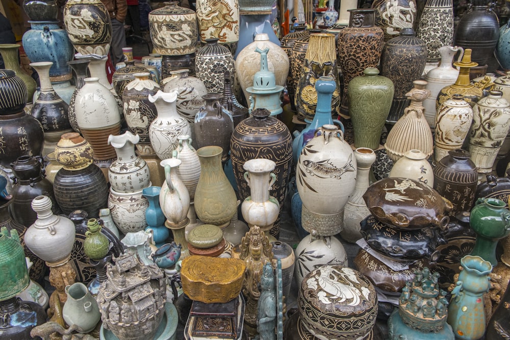 a bunch of vases that are sitting on a table
