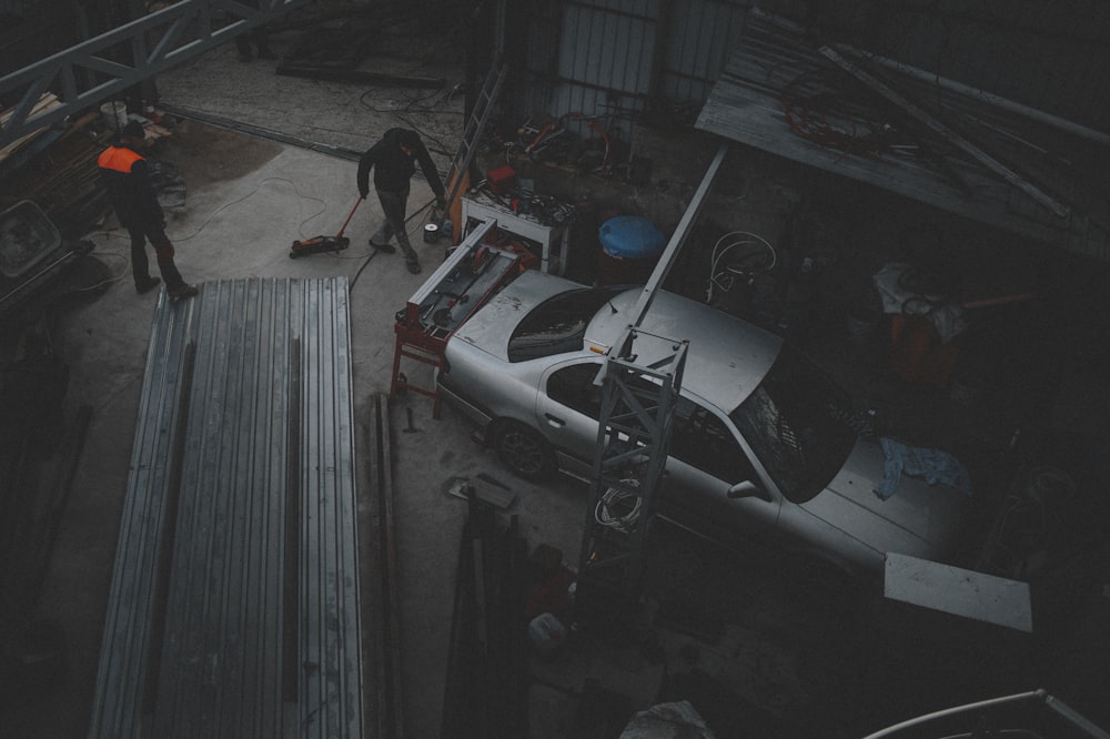 two men working on a car in a garage