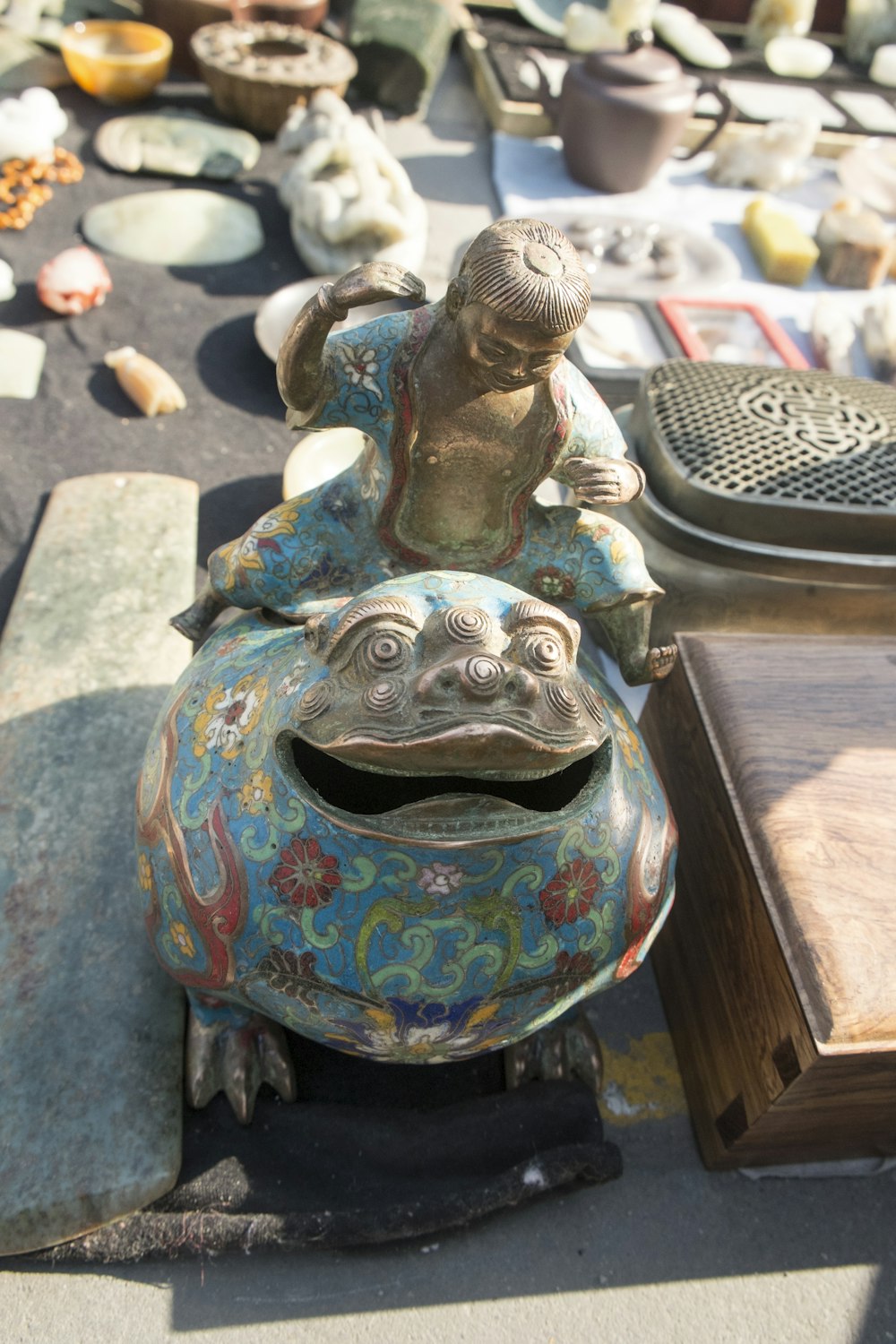 a statue of a person riding a fish on top of a table