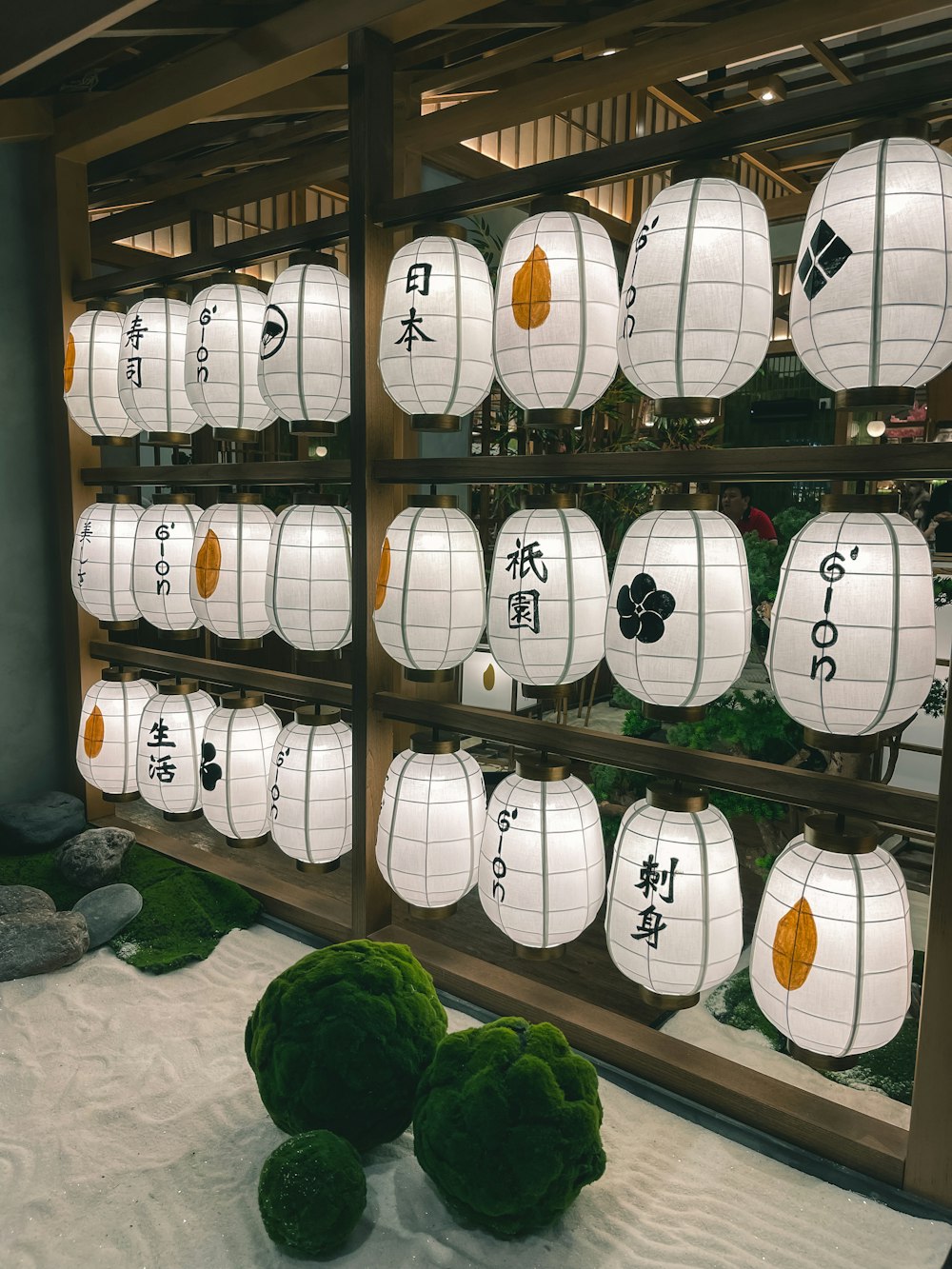 a display of paper lanterns with asian writing on them