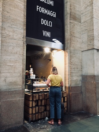 A friendly local business owner smiling in front of their Ticino shop.