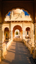 a large white building with pillars and arches