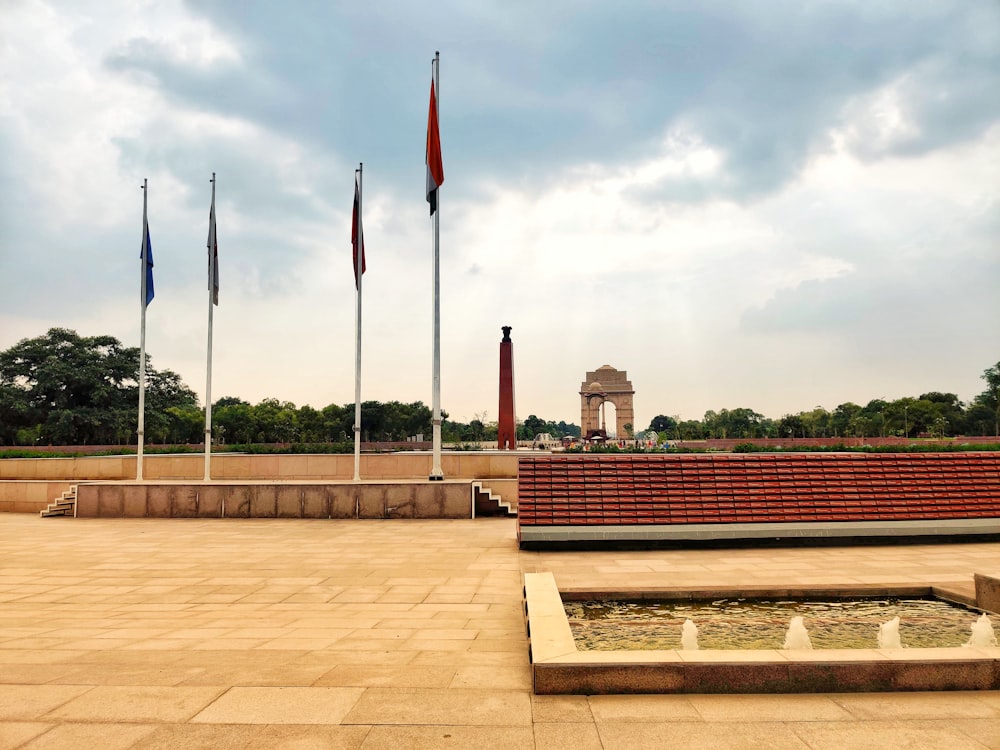 a view of a park with flags flying in the wind