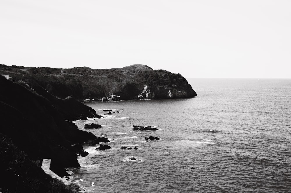 a black and white photo of a rocky coastline