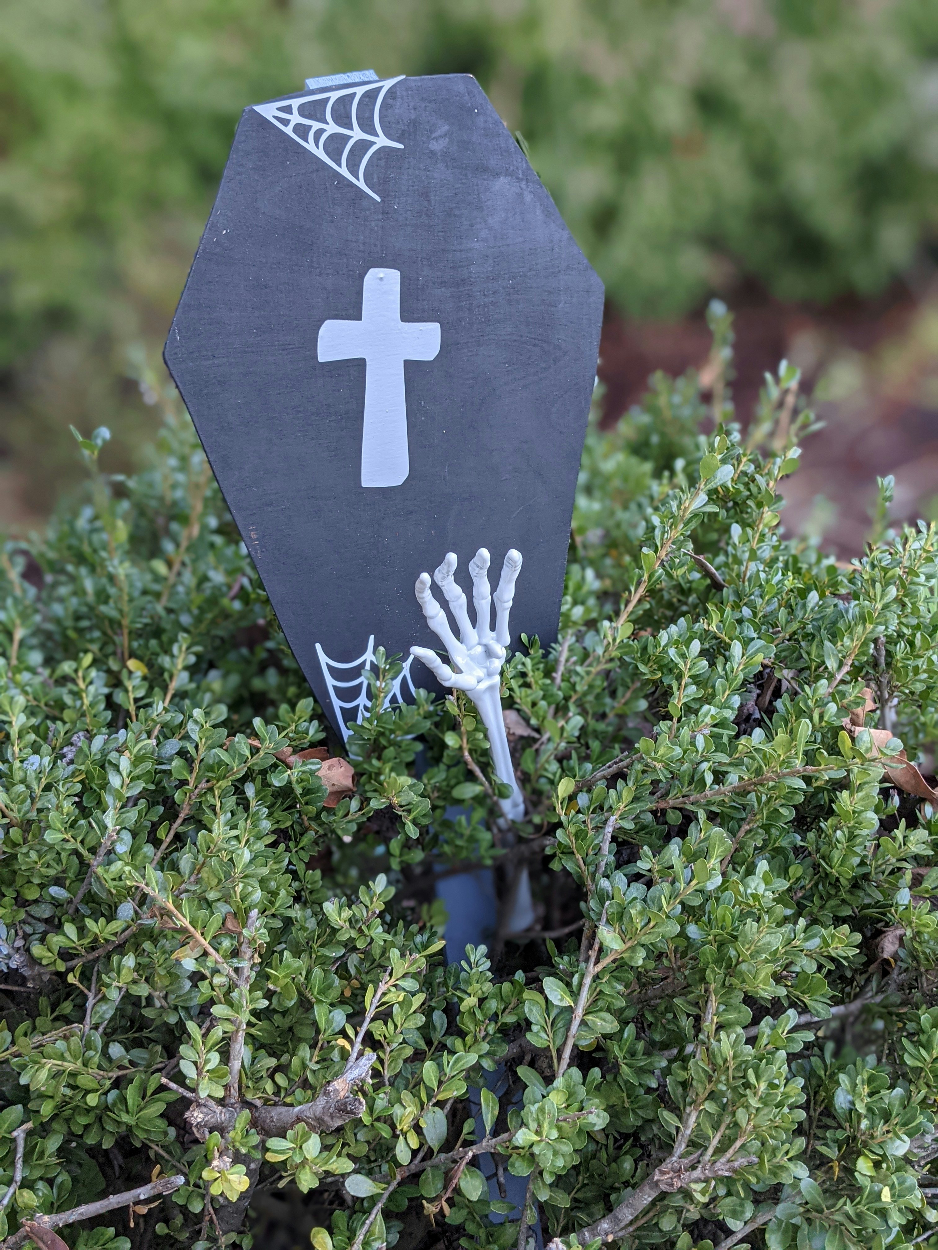 a black sign with a white cross on it