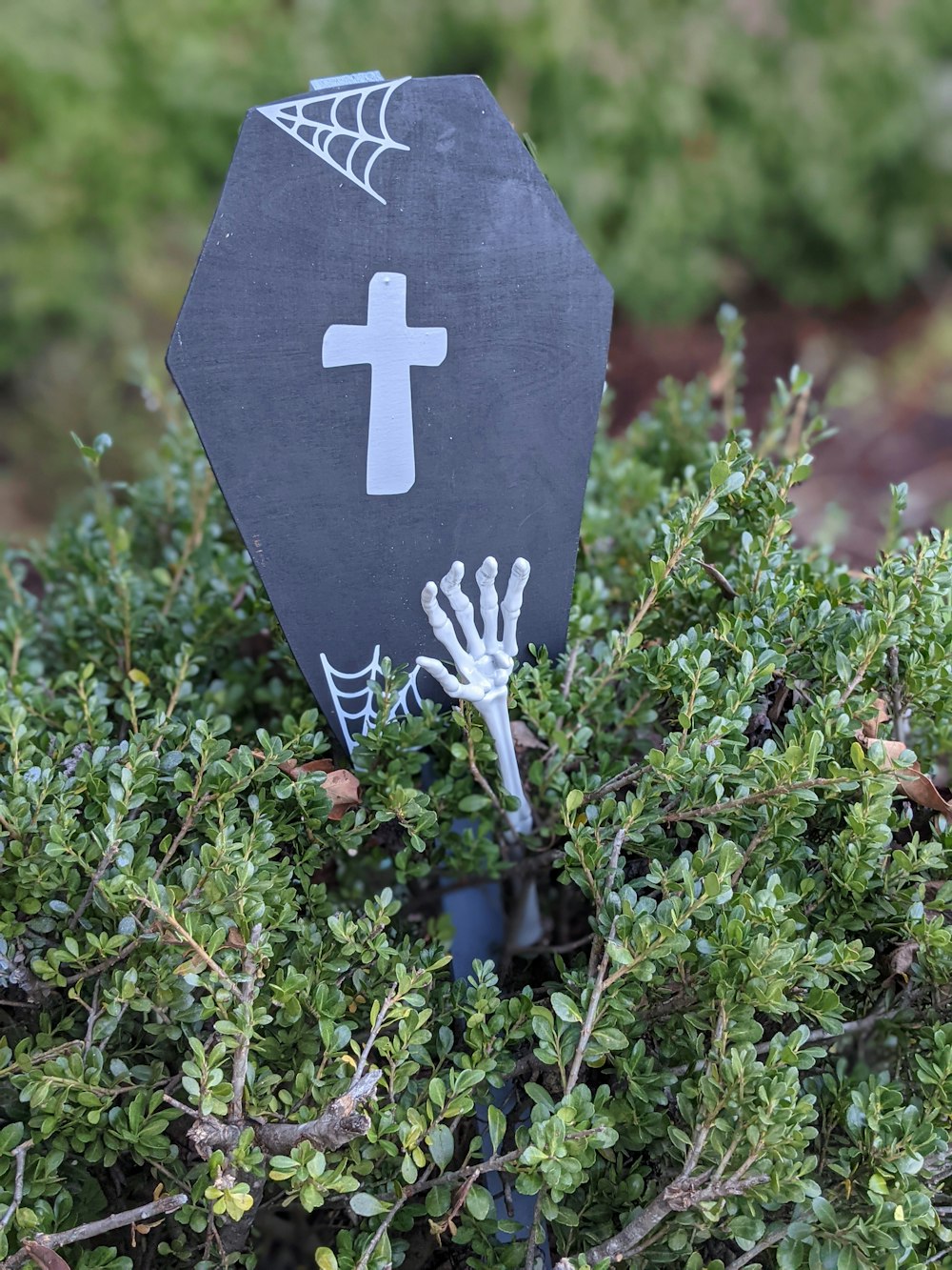 a black sign with a white cross on it