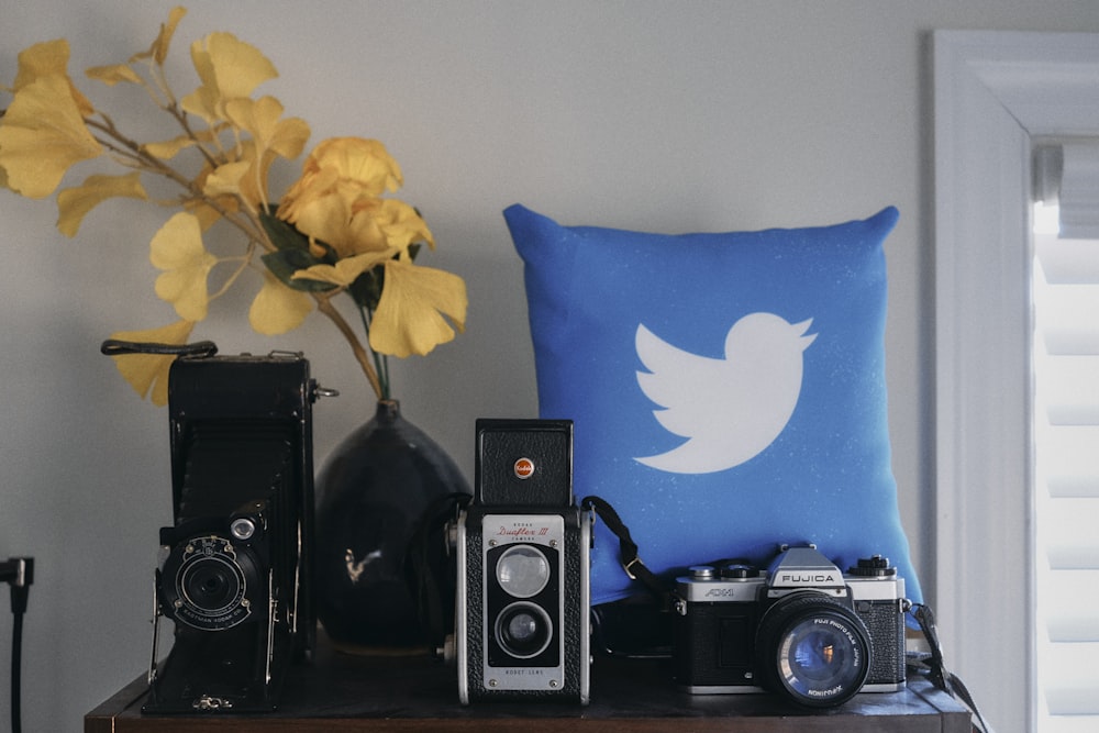 a blue pillow sitting on top of a wooden table