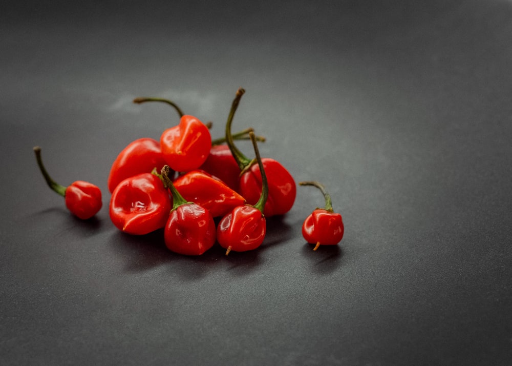 a pile of red peppers sitting on top of a table