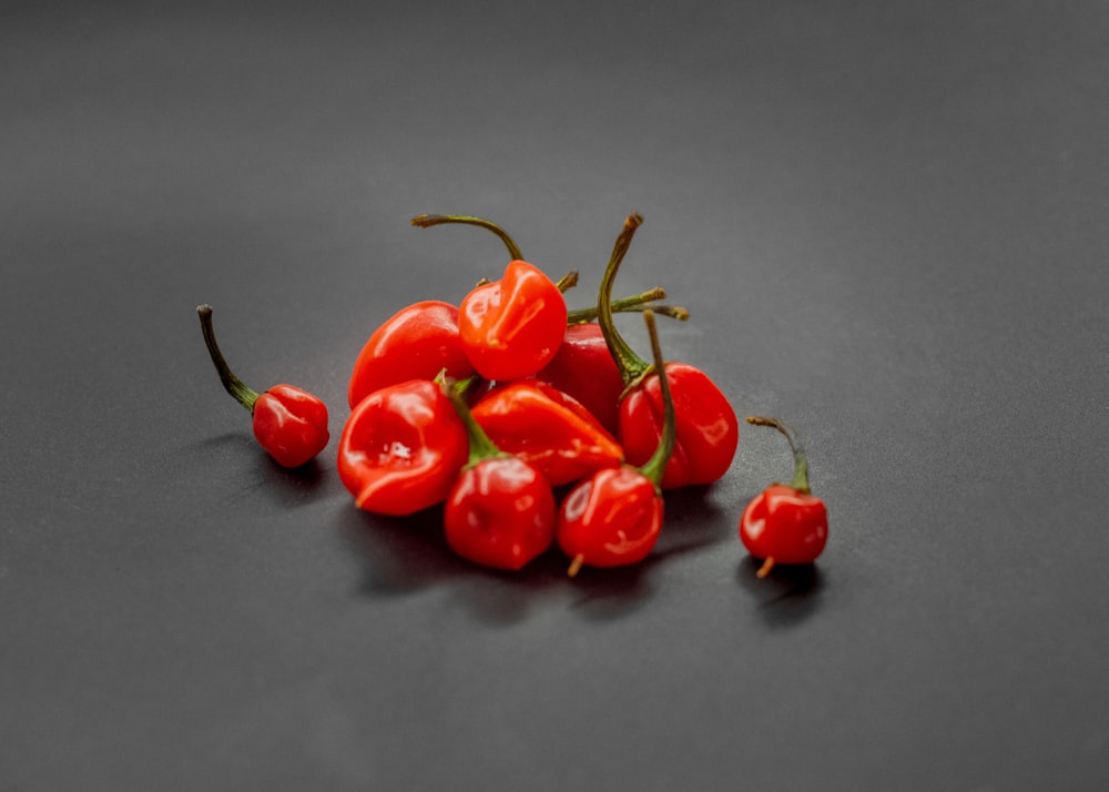 a pile of red peppers sitting on top of a table