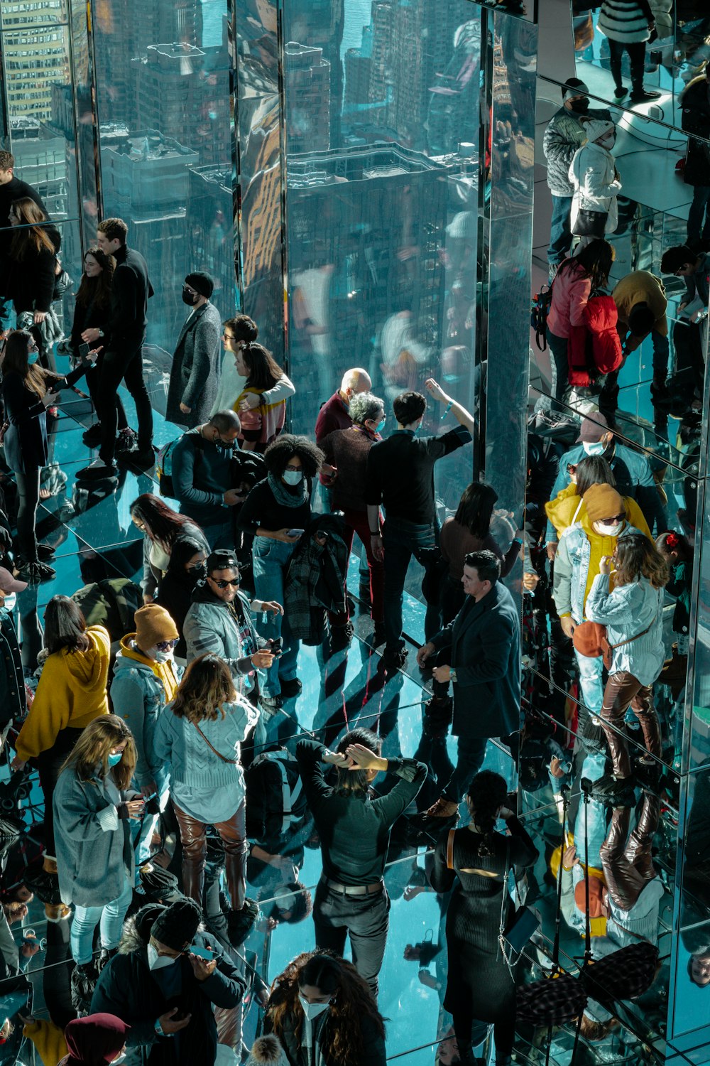 a group of people standing around a glass room