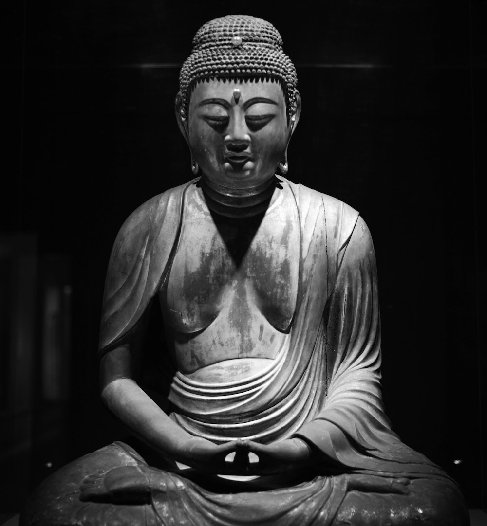 a buddha statue sitting in the middle of a room