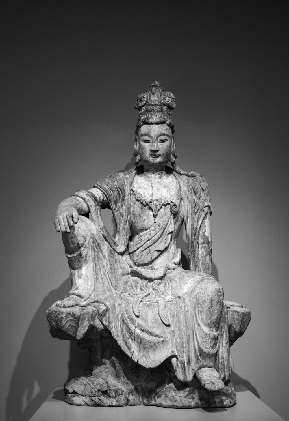 a black and white photo of a buddha statue