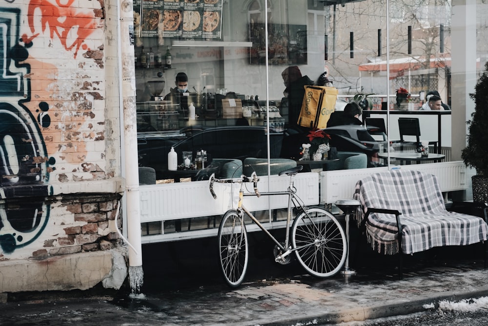 a bicycle parked in front of a store window