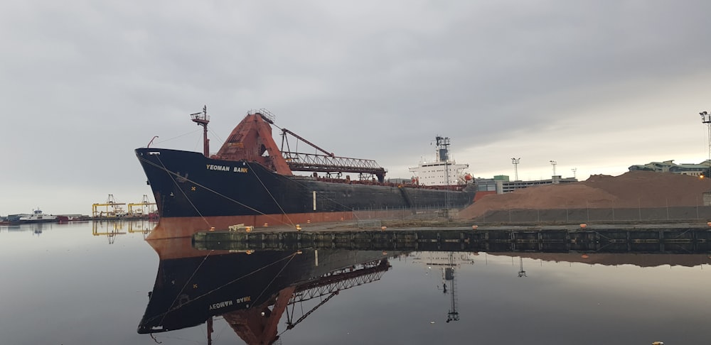 a large boat is docked at a dock