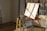 A serene art studio filled with colorful paintings and natural light streaming through large windows.