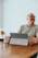a man sitting at a table with a laptop