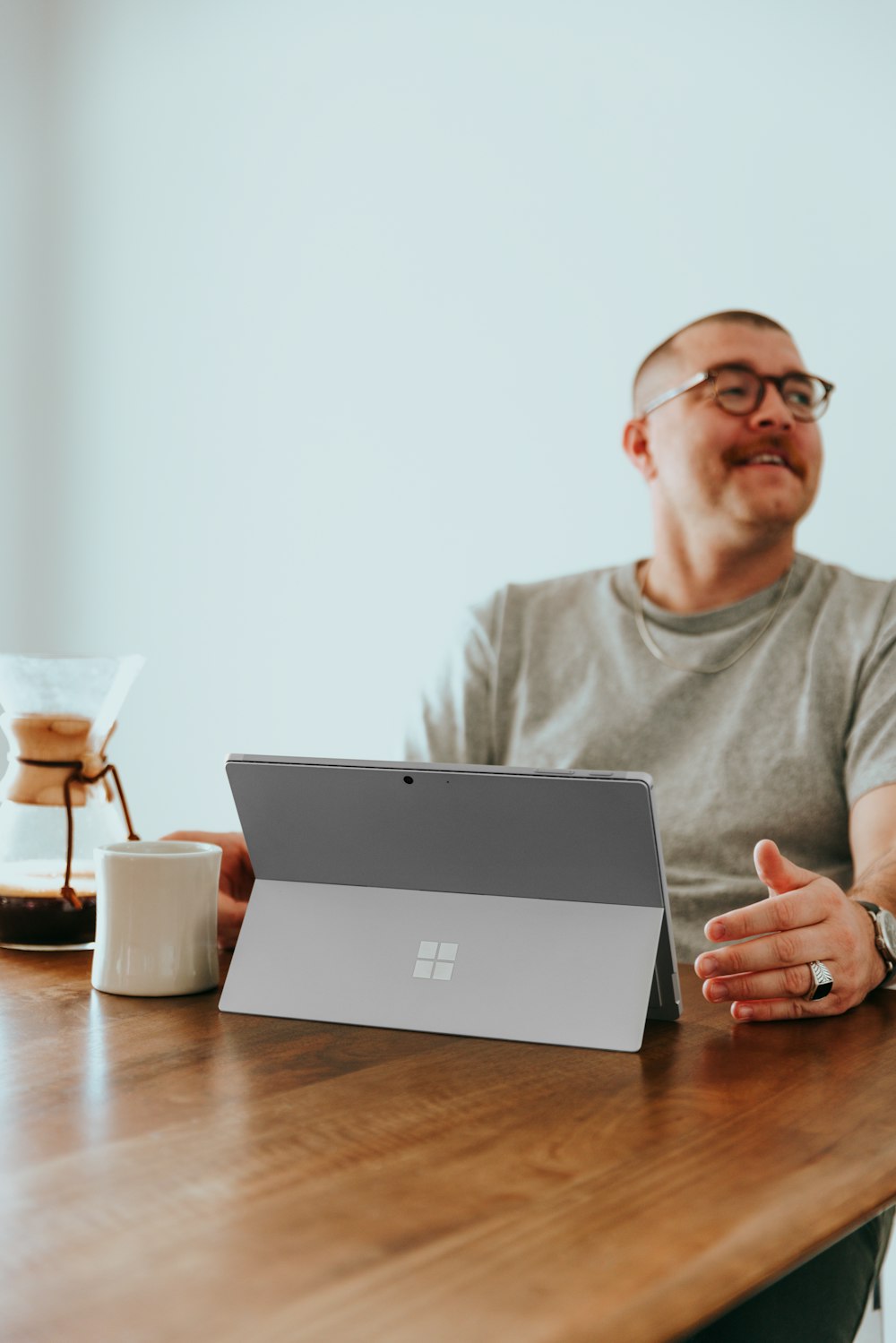 a man sitting at a table with a laptop