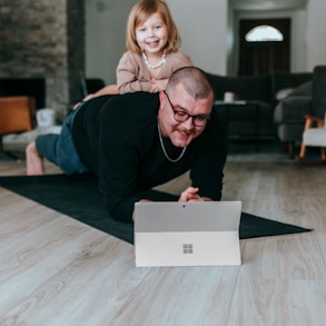 a man and a little girl playing on the floor