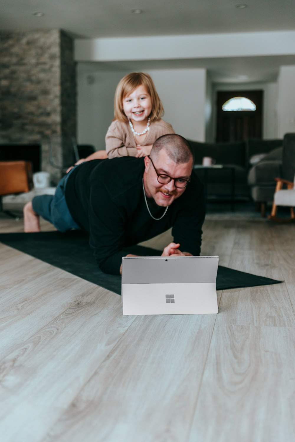 a man and a little girl playing on the floor