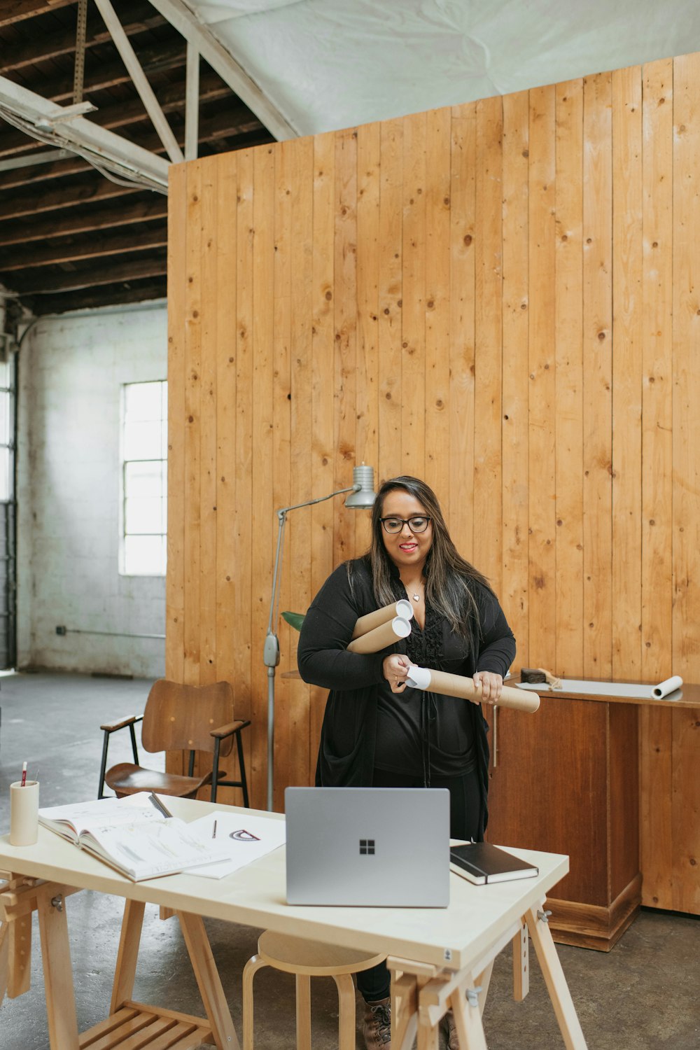 a woman holding a baseball bat in front of a laptop