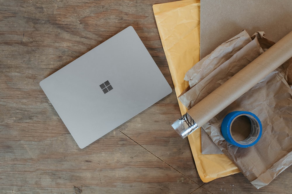 a laptop computer sitting on top of a wooden table