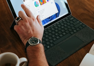 a man sitting at a table using a laptop computer