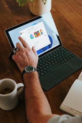 a man sitting at a table using a laptop computer