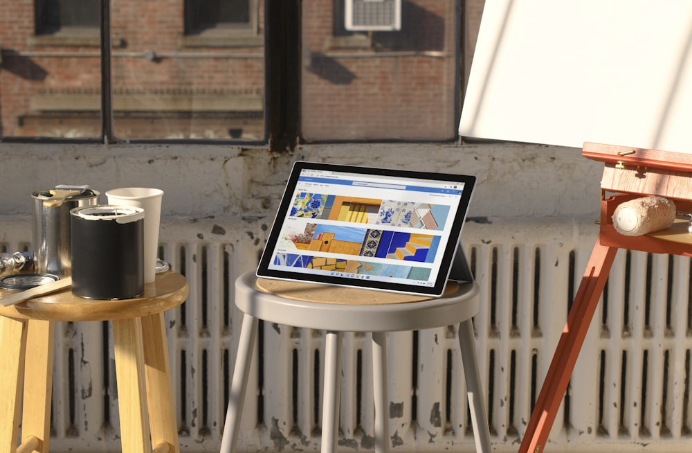 a laptop computer sitting on top of a wooden table