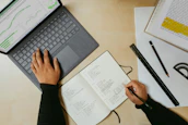 a person sitting at a desk working on a laptop