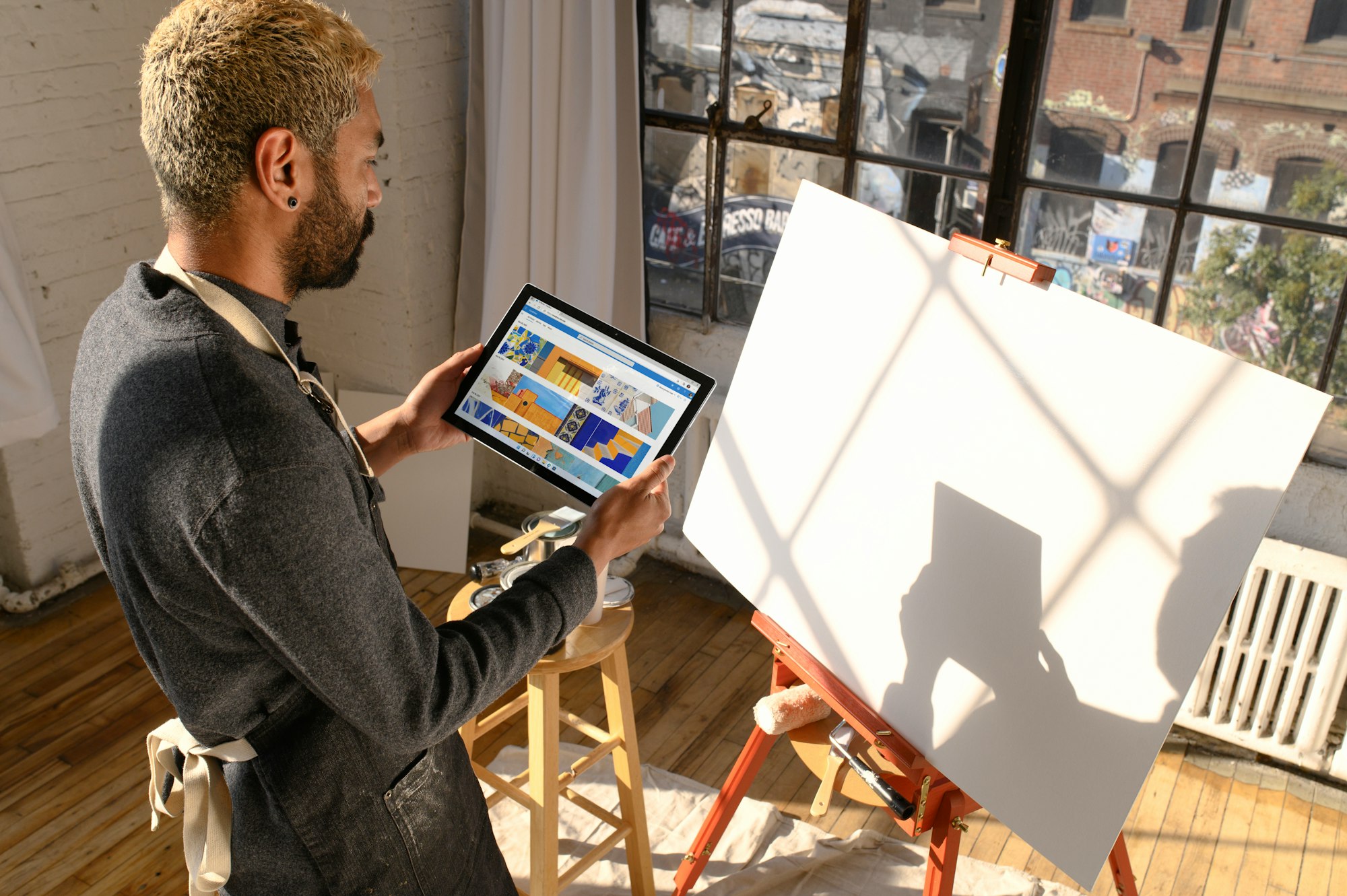 Person looking at a canvas that they will paint