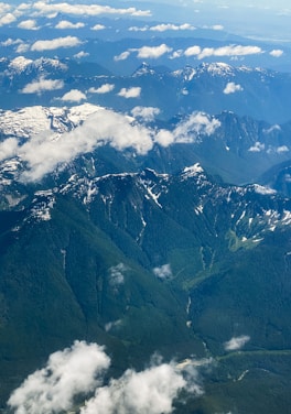 Aerial view of a scenic landscape with mountains and forests.