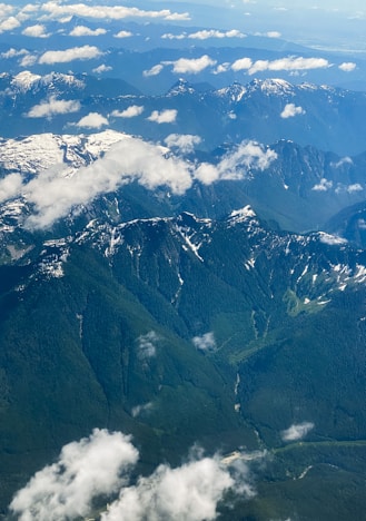 Aerial view of a scenic landscape with mountains and forests.