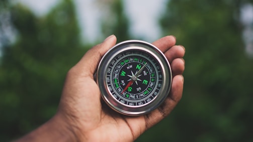 a person holding a compass in their hand