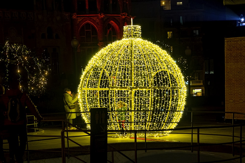a large lighted ball in the middle of a street