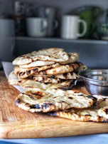 Freshly baked Moroccan bread resting on a rustic wooden board, ready to be shared.
