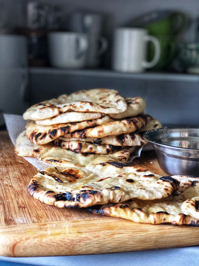 Blistered garlic naan brushed with butter and coriander