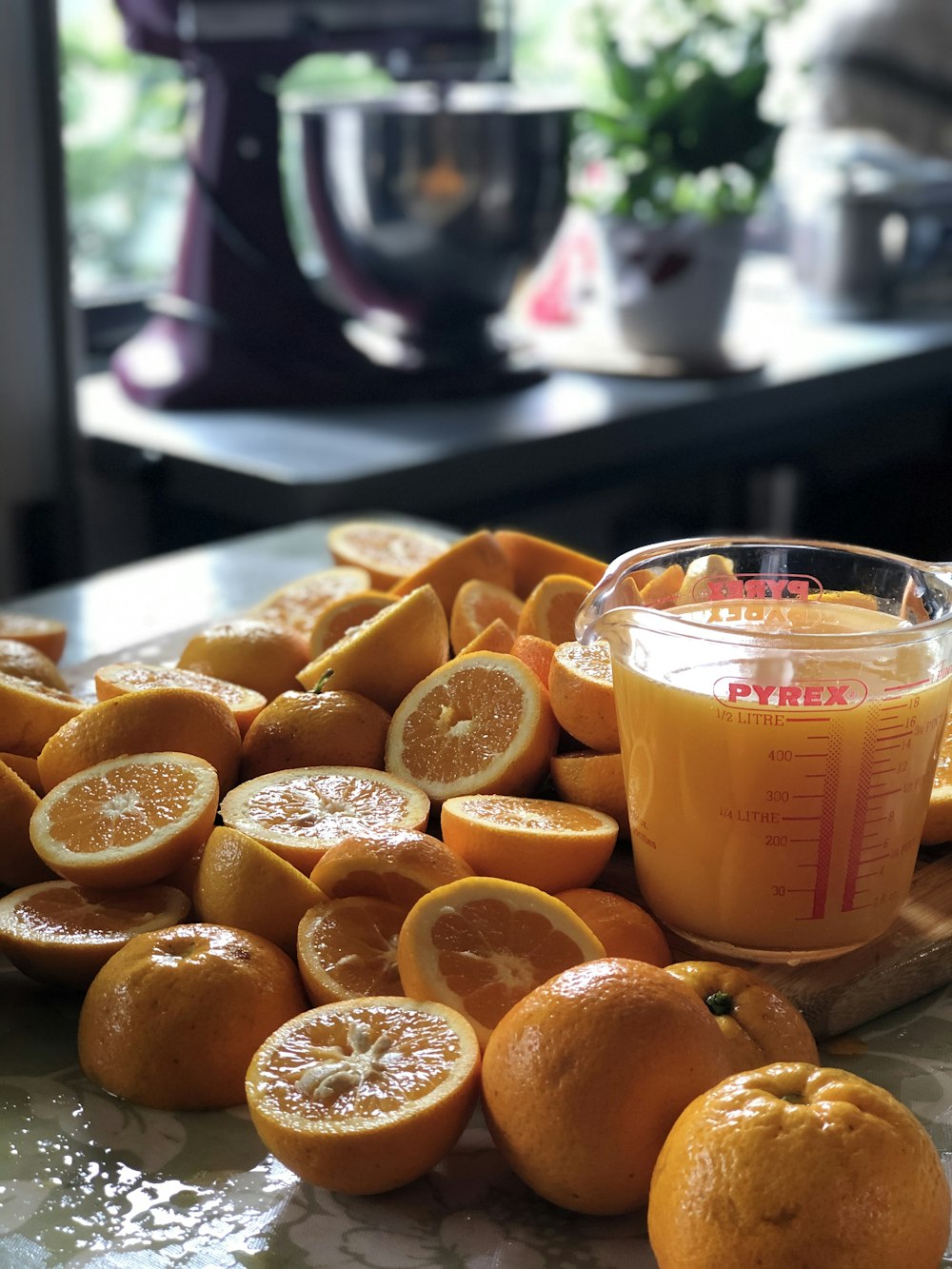a table topped with oranges and a jar of orange juice